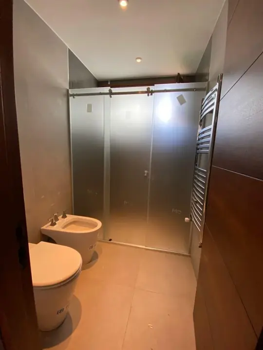 Mampara corredera de cristal en baño con madera