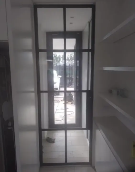 Puerta de cristal con perfilería negra estilo industrial